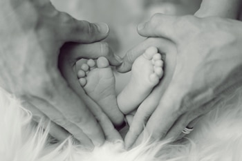 Baby-Feet Mother and Father Holding Baby Feet